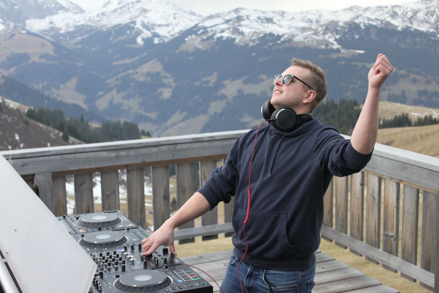 Sas Cras at the decks on the Hahnenmoos terrace, arm raised