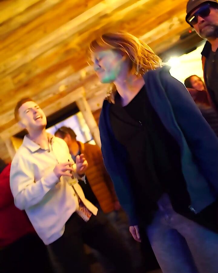 Guests laughing and dancing at night