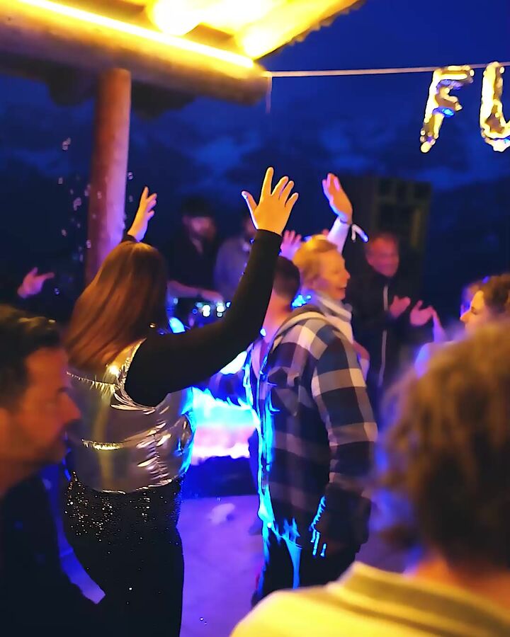 Hands up under the lights after dark